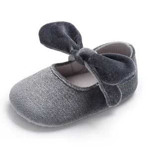 Detailed view of a grey velvet baby princess shoe featuring a large bow and soft sole design