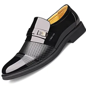 Classic black men's business dress leather shoes with hollow-out perforated design.