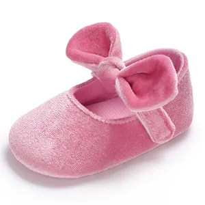 Detailed view of pink velvet baby princess walking shoes featuring a decorative large bow