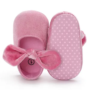 Detail of pink velvet baby princess shoes with large bow and non-slip sole