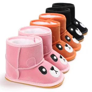 Detailed view of adorable cartoon animal face infant winter boots with warm plush lining