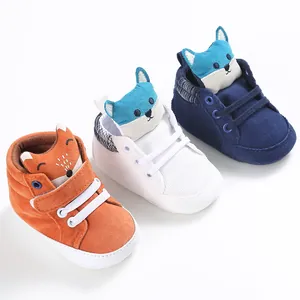 Close-up of cute fox-themed baby walking shoes in orange, white, and navy blue