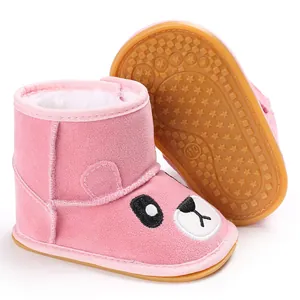 Pink baby winter snow boots with cartoon face and non-slip rubber sole detail
