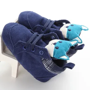 Close-up of baby walker shoes featuring soft corduroy and cute fox character