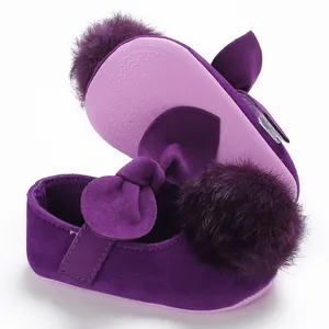 Vue détaillée de chaussures de princesse pour bébé violettes avec pompon et nœud