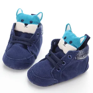 Close-up of navy corduroy baby walking shoes with cute blue plush fox design