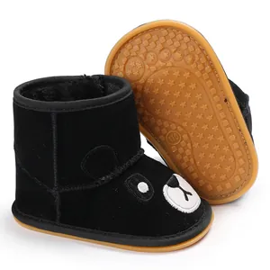 Detail of black cartoon baby boots showing anti-slip gum sole and soft fleece lining