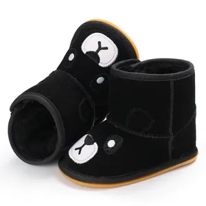 Detail view of winter baby boots with black plush lining and bear face embroidery