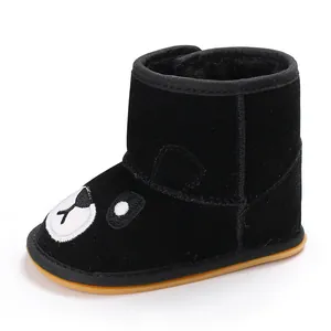 Detail view of black winter baby boot with cartoon bear design and thick warm lining