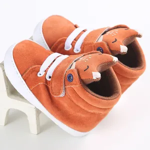 Close-up of cute orange fox baby walker shoes with soft soles and white elastic laces