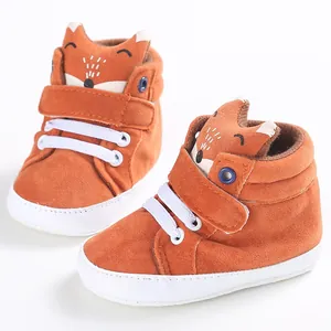 Close-up detail of cute orange fox baby pre-walker shoes featuring soft white soles