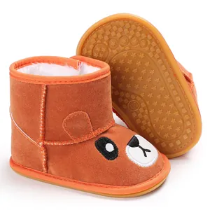 Detailed view of brown cartoon bear baby snow boots with non-slip star pattern rubber sole