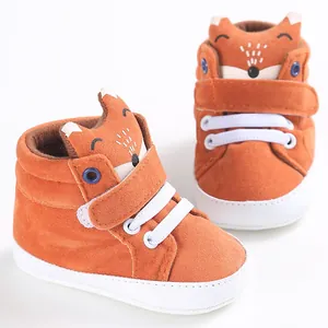 Close-up of orange baby walker shoes with cute fox character and soft sole