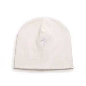 Detailed view of a soft white infant beanie hat with central cross embroidery design.