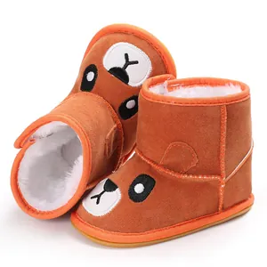 Cozy brown infant winter boots with cute cartoon bear design and thick white faux-fur lining