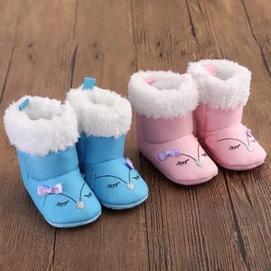 Detailed view of baby winter snow boots in blue and pink with cute fox embroidery