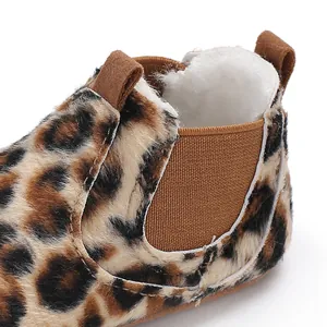 Detailed macro view of leopard print baby bootie featuring warm white plush fleece lining