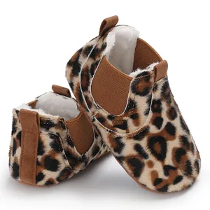 Detail view of leopard print faux-fur infant booties featuring soft white fleece lining