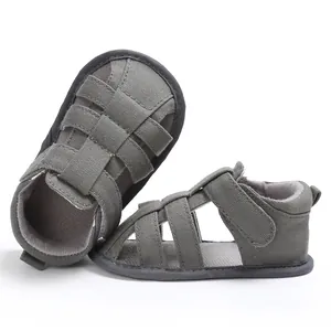 Close-up of grey canvas baby sandals with soft anti-slip sole and velcro strap details.
