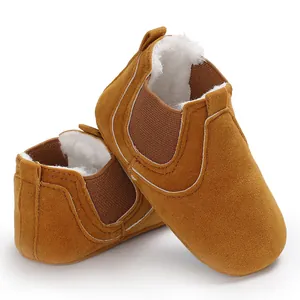 Cozy brown winter walking shoes for infants with thick white faux fur lining detail