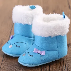 Close-up of blue baby winter snow boots with soft plush lining and fox embroidery