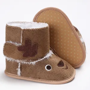 Close-up detail of brown plush baby reindeer boots featuring non-slip soft soles and warm lining