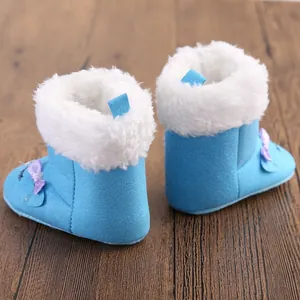Light blue baby winter snow boots with white faux fur lining and purple bow detail