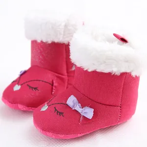 Detail view of pink baby winter snow boots with soft faux fur and cute bow decoration