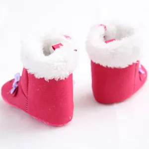 Detail view showing the back of fuchsia baby boots with white faux fur and bows