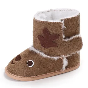 Side detail of brown baby winter boots with soft sole and reindeer cartoon design