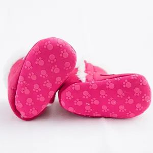 Close-up detail of pink baby snow boots featuring anti-slip paw print soft soles for winter