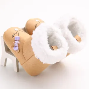 Close-up of baby girl winter snow boots with soft fleece lining and cute bow detail