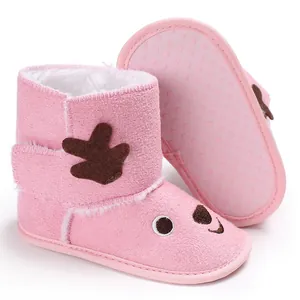 Detailed view of pink baby winter boots with soft fleece lining and cute reindeer design