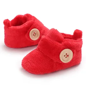 Soft red plush winter baby boots for infants with decorative wooden buttons detail