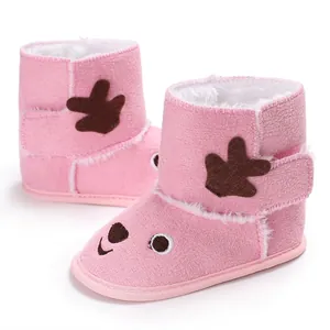 Close-up of pink baby winter boots featuring a cute reindeer design and soft fleece interior