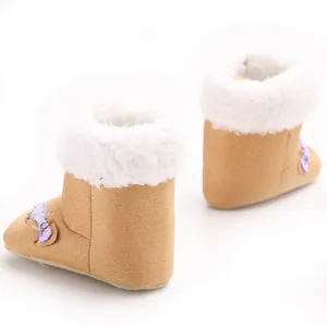 Rear view of warm camel infant snow boots with soft white faux fur lining and purple bow detail