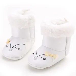 White baby girl winter snow boots with cute fox face and soft fur trim.