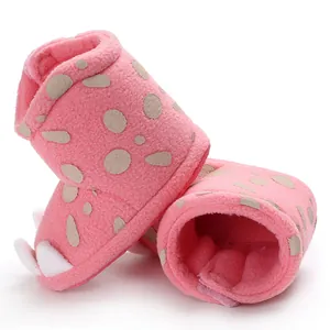 Macro shot of pink fleece baby boots featuring adorable claw design and warm soft soles.