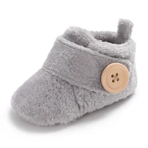 Macro detail view of soft grey plush fleece baby pre-walker shoe with wooden button