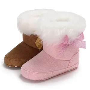 Cozy pink and brown baby snow boots with faux fur trim and glitter bow detail.