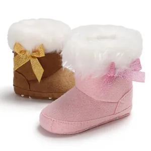 Detail view of pink and brown baby snow boots with fluffy faux fur and glitter bows