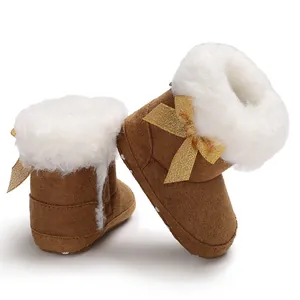 Cozy brown winter baby snow boots featuring soft white faux fur lining and a gold bow detail.