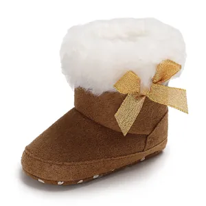 Detailed view of warm baby snow boot with soft fur lining and a decorative gold bow
