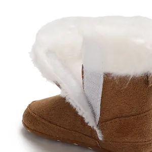 Close-up of baby winter snow boot with soft white fur lining and velcro closure.