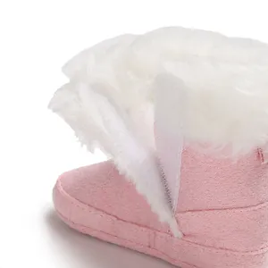Detailed macro view showing the soft white faux fur lining of pink baby winter snow boots