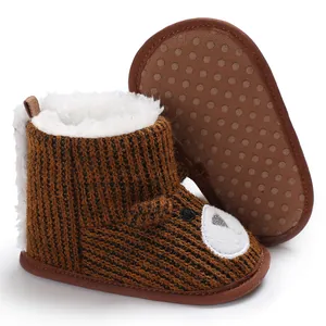 Close-up of brown knit baby bear boots with soft non-slip sole and warm fur lining.