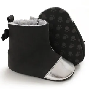 Detailed view of warm black winter baby boots featuring soft anti-slip soles and silver toe caps