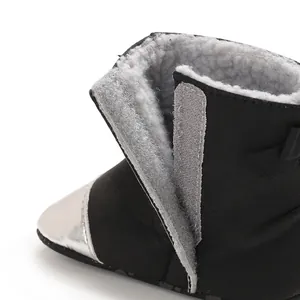 Close-up detail of the warm grey faux fur lining and velcro fastener on baby winter boots