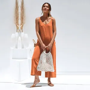 Tuta da donna arancione bruciato a gamba larga con spalline regolabili in studio