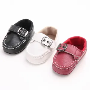 Detailed view of baby walking shoes in black, white, and red with soft soles